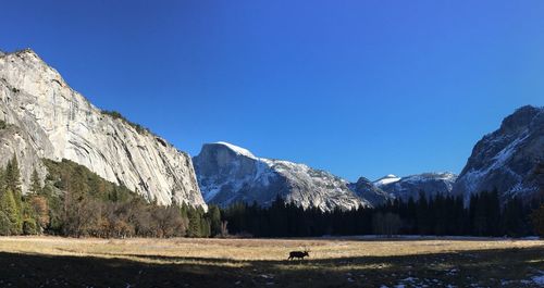 Scenic view of mountains against blue sky