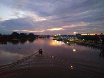 Scenic view of river against sky at sunset