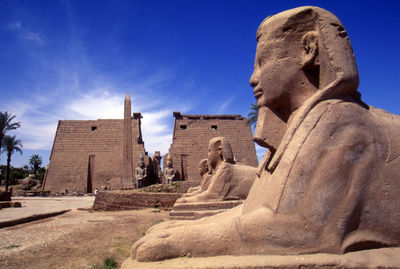 Statue in karnak temple against sky
