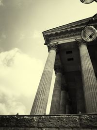 Low angle view of building against cloudy sky