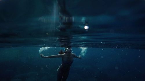 Young woman swimming undersea