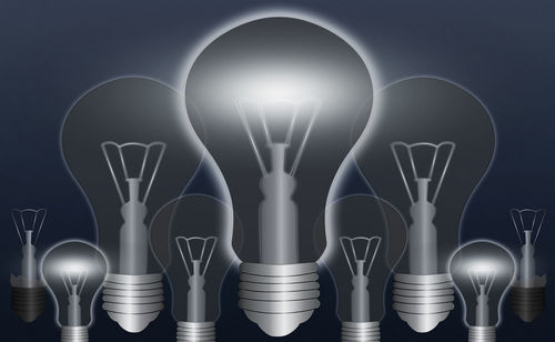 Digital composite image of illuminated light bulb