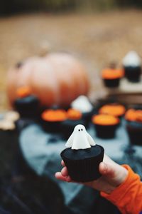 Cropped hand holding cupcake