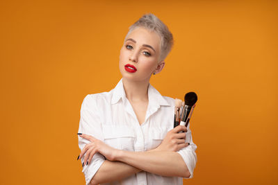 Portrait of a young woman against gray background