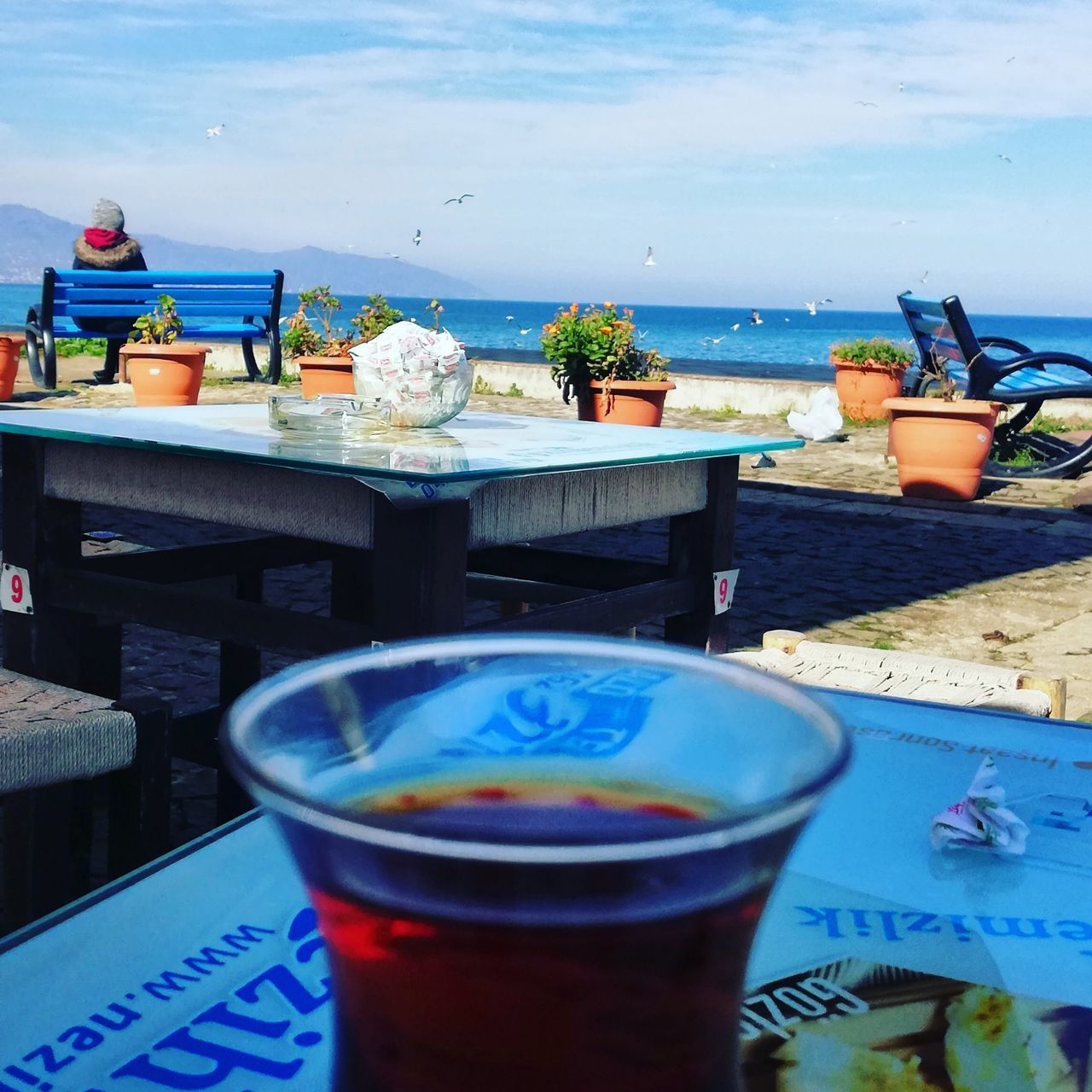 TEA CUP ON TABLE AT BEACH