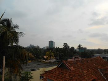 View of cityscape against cloudy sky