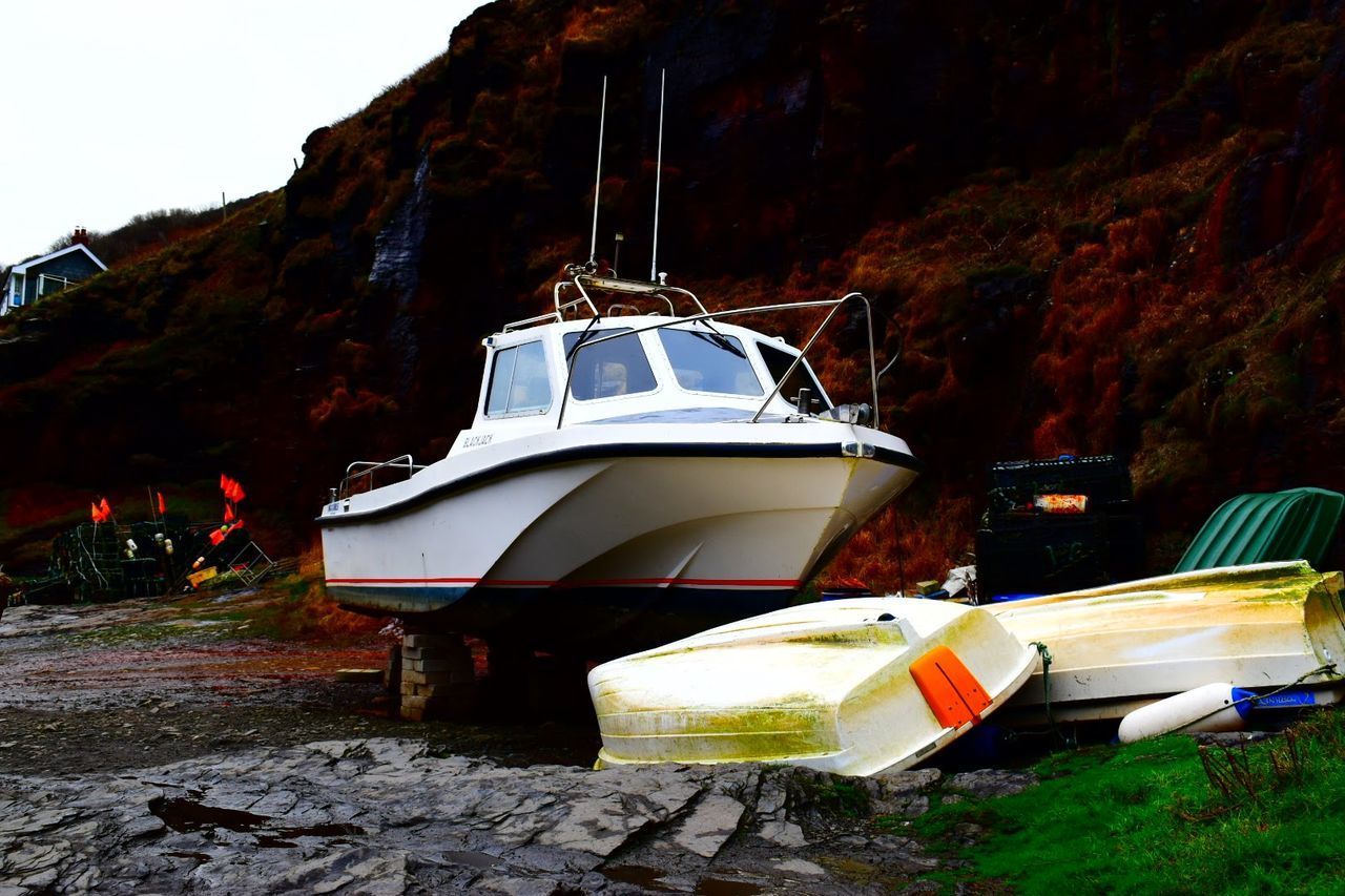 BOAT MOORED ON SHORE