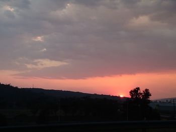Silhouette trees against sky during sunset