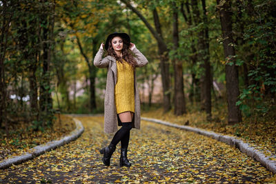 Full length of woman standing in forest