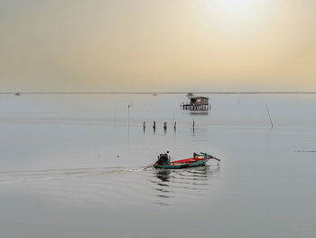 Coastal fishing boats are sailing after raining on sunset at the bay of bangsaen, thailand.