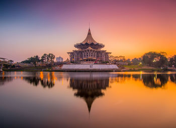 Reflection of building in lake during sunset