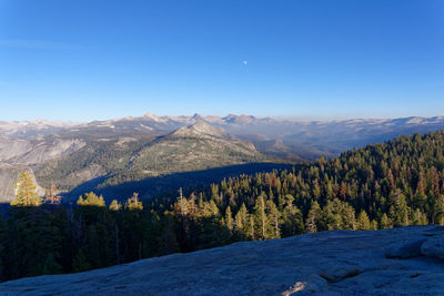 Scenic view of mountains against clear blue sky