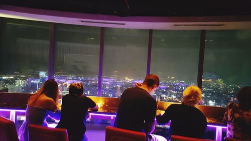 People standing in illuminated city at night