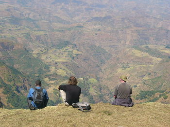 Men sitting on mountain road