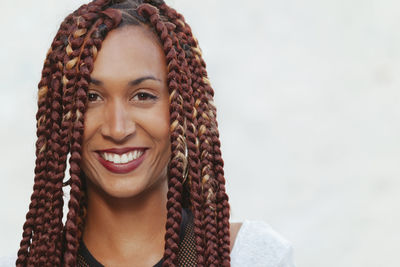 Close-up portrait of smiling woman with braided hair