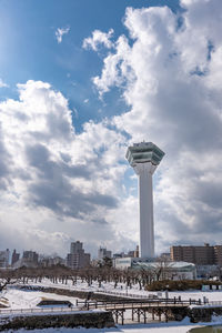 Communications tower in city during winter