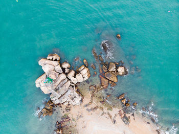 Aerial view of rocks by sea