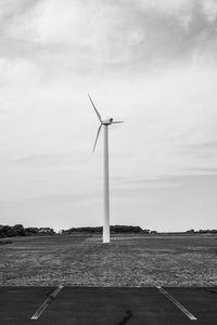 Windmill on field against sky