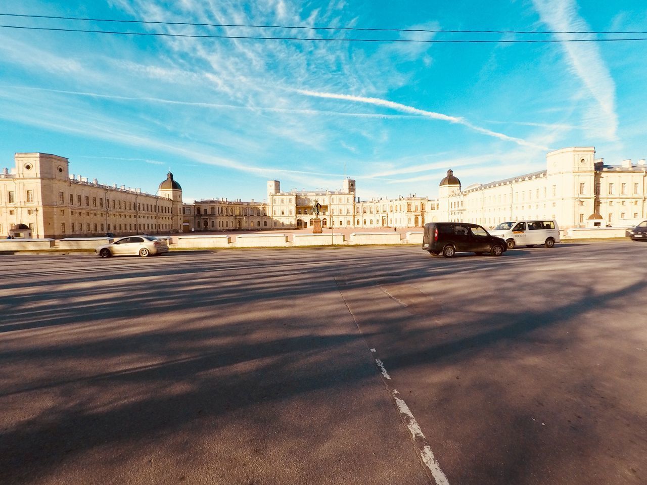 STREET BY BUILDINGS AGAINST SKY