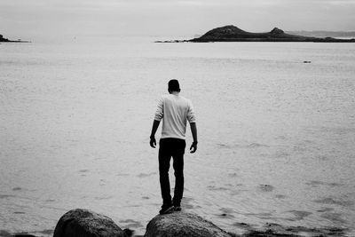 Rear view of woman standing on beach