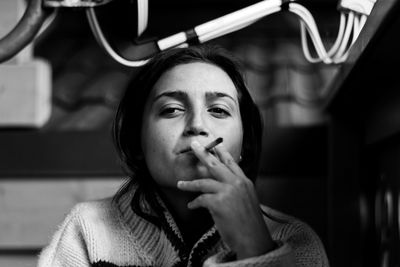 Close-up of young woman smoking cigarette