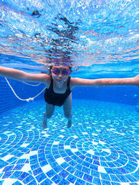 Portrait of man swimming in pool