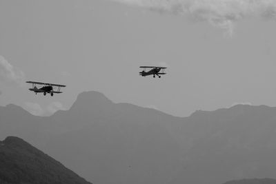 Low angle view of two airplane flying in sky