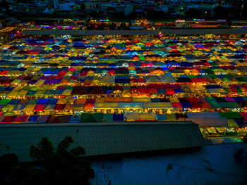 High angle view of multi colored buildings at night