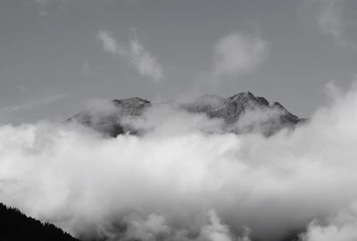 Scenic view of mountains against cloudy sky