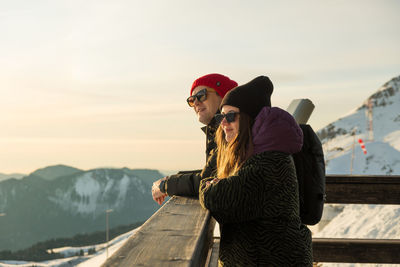 Couple enjoying winter sunny weather holiday ski resort outdoors. caucasian happy young people