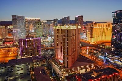 High angle view of illuminated cityscape against sky at night