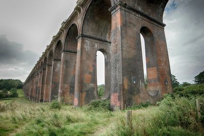 Low angle view of arch bridge against sky