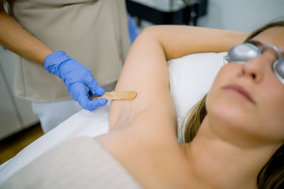 Midsection of doctor examining patient in hospital