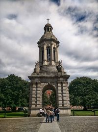 People at temple against sky