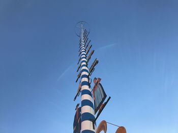 Low angle view of windmill against clear blue sky