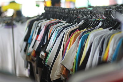 Close-up of clothes hanging on rack in store