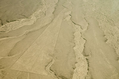 Full frame shot of tire tracks on sand