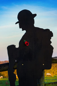 Silhouette man standing on field against sky