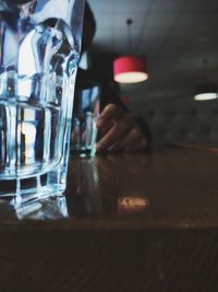 Close-up of person drinking glass on table