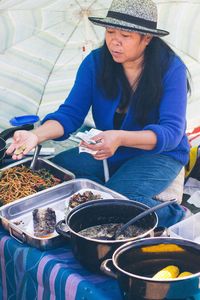 High angle view of woman holding food on table