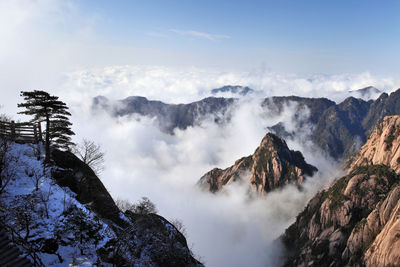 Scenic view of rocky mountains during foggy weather