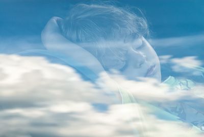 Portrait of boy in sea against sky