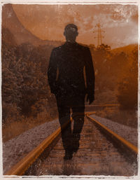 Rear view of man walking on water