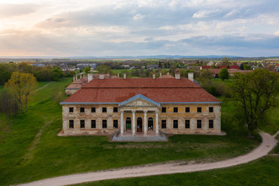 Aerial view about abandoned cziraky castle with cloudy sky at the background.