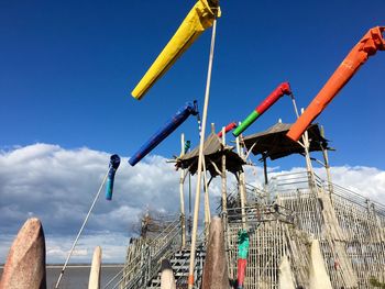 Low angle view of windsocks against sky