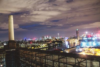 View of cityscape against cloudy sky