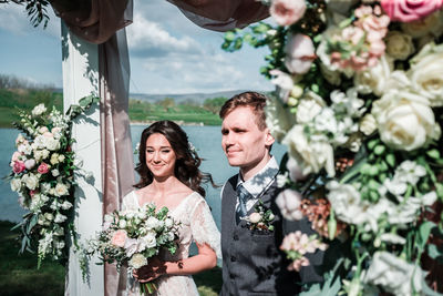 Couple standing by flowering plants