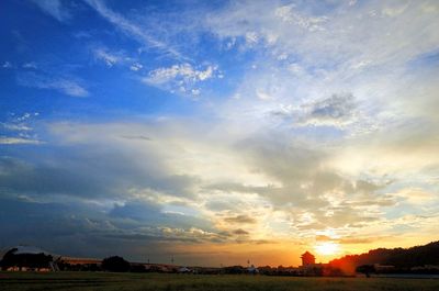 Scenic view of landscape against sky at sunset