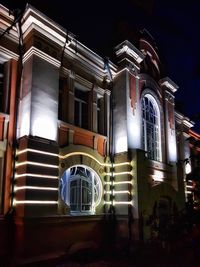 Low angle view of illuminated building at night