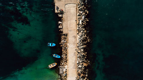 Aerial view of the breakwater in the sea and small boats. beautiful abstract natural background.